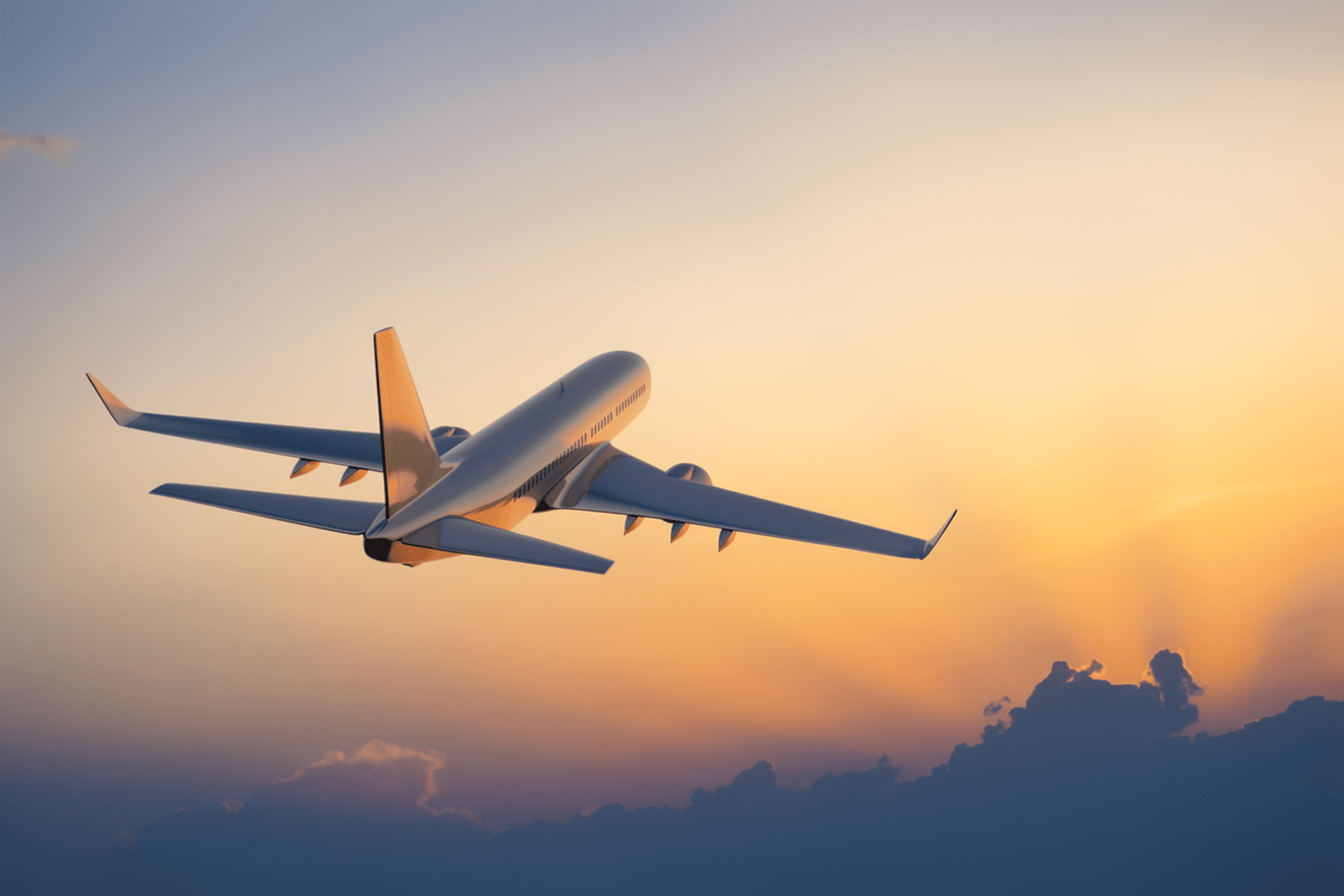 Airplane wing above clouds at sunrise